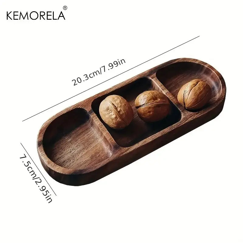 Dark brown acacia wood oval three-compartment dip plate holding whole walnuts by decorbites