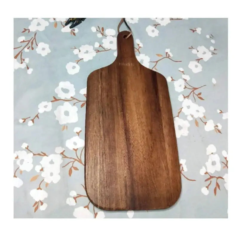 A sleek dark brown acacia wooden chopping block with smooth finish and rounded edges by decorbites