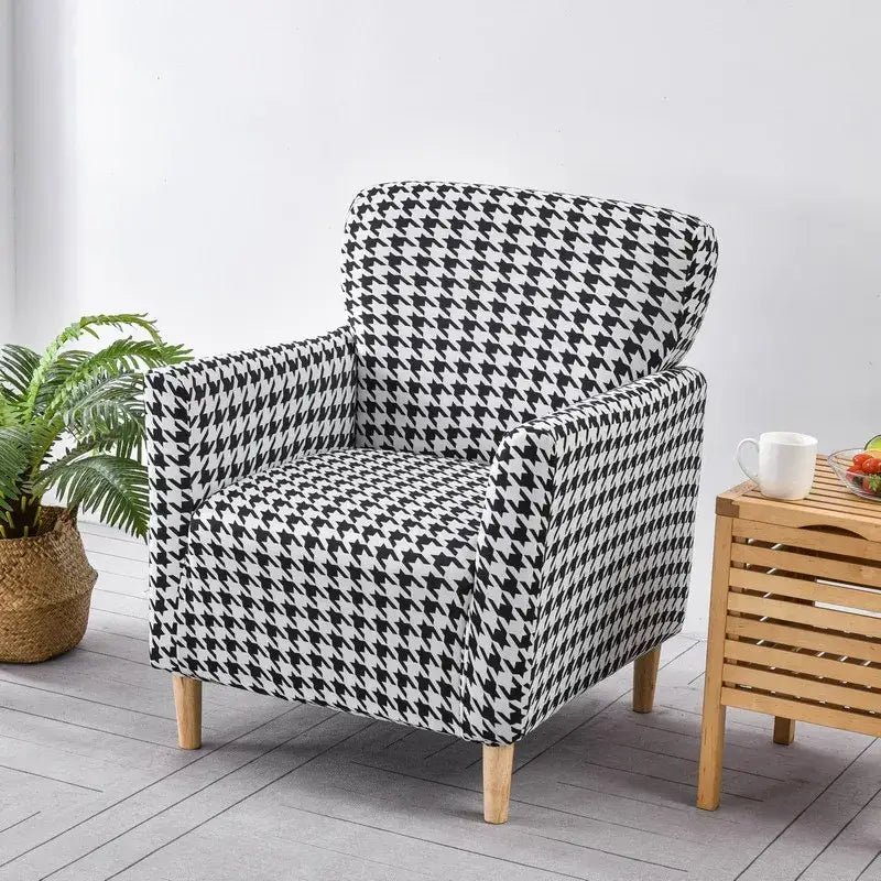 DecorBites™ accent chair cover slipcover on a black and white houndstooth patterned armchair with wooden legs