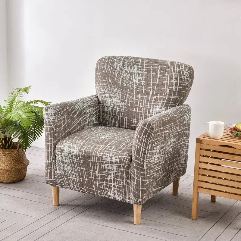 Gray fabric accent chair with white abstract grid pattern and light wooden legs featuring DecorBites accent chair cover slipcover