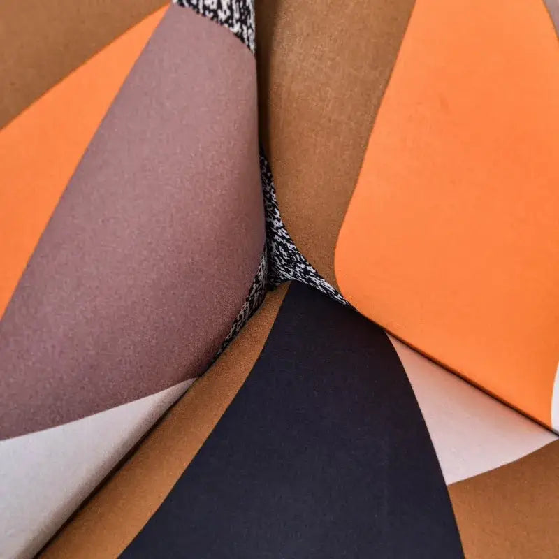 DecorBites™ accent chair cover slipcovers with stretch fabric in bold orange, muted brown, soft pink, and black geometric design