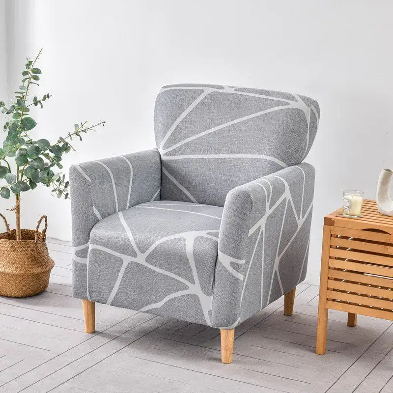 Gray accent chair with modern white geometric pattern upholstered in textured fabric with light wooden legs slipcover