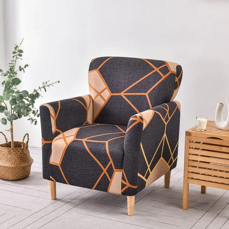 A stylish accent chair with a dark gray fabric stretch accent chair cover featuring tan and orange geometric patterns
