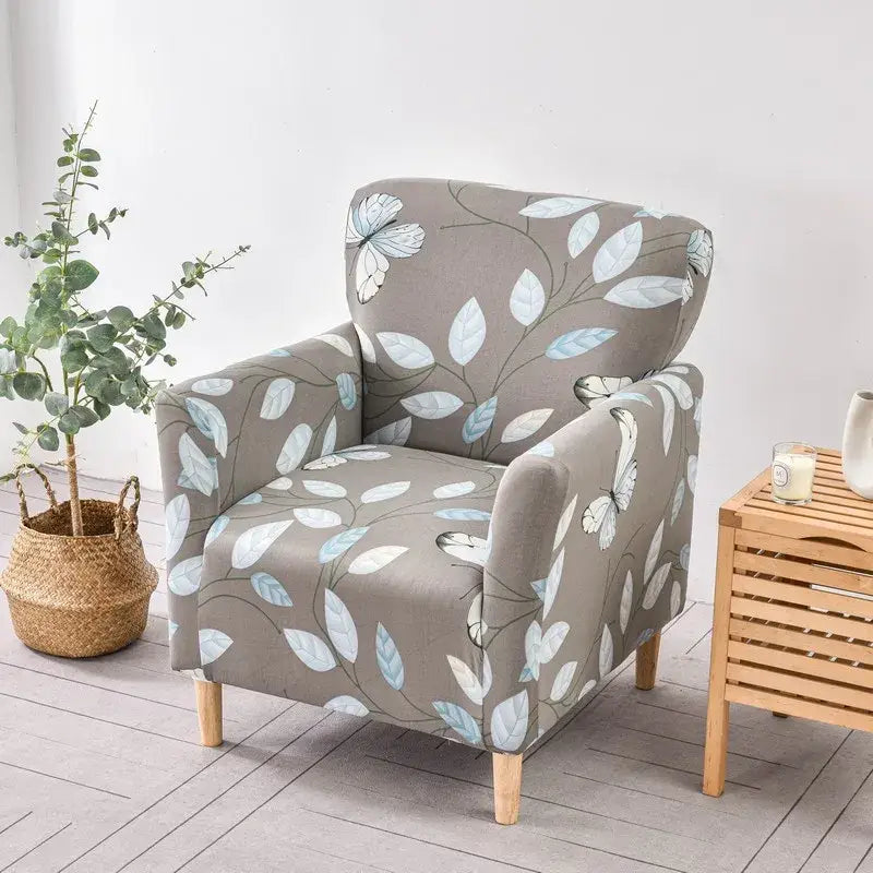 Gray DecorBites™ accent chair cover slipcovers featuring white and light blue leaf and butterfly pattern snugly fitted
