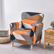 DecorBites™ accent chair cover slipcovers featuring a vibrant orange white black and speckled gray geometric pattern