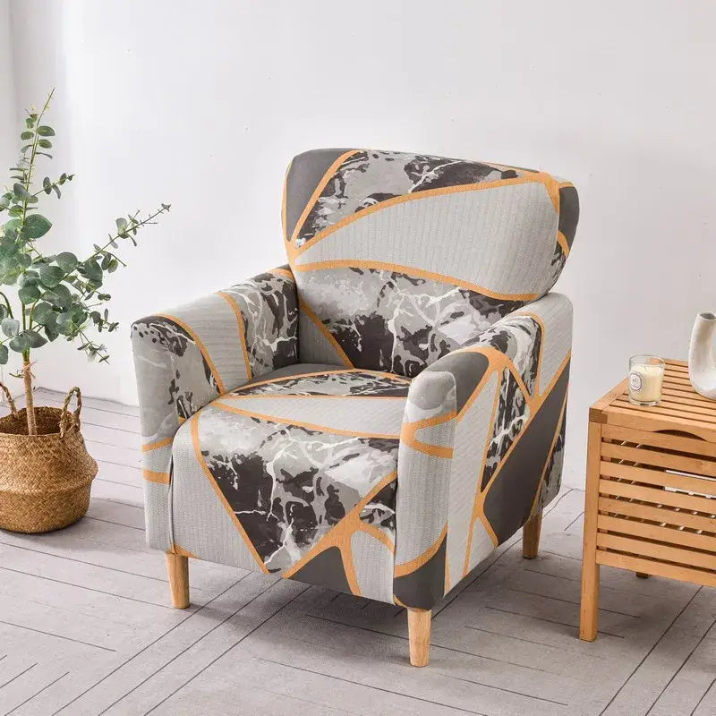 Gray and black marble-patterned accent chair with bold orange geometric stretch fabric slipcover by decorbites