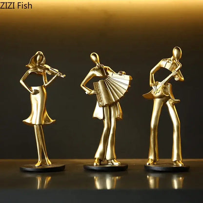 Set of three golden metallic musician resin sculptures featuring an accordion musician violin and guitar for decor