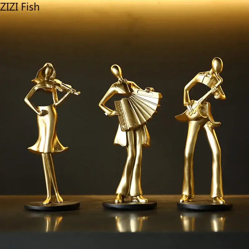 Set of three golden metallic musician resin sculptures featuring an accordion musician violin and guitar for decor