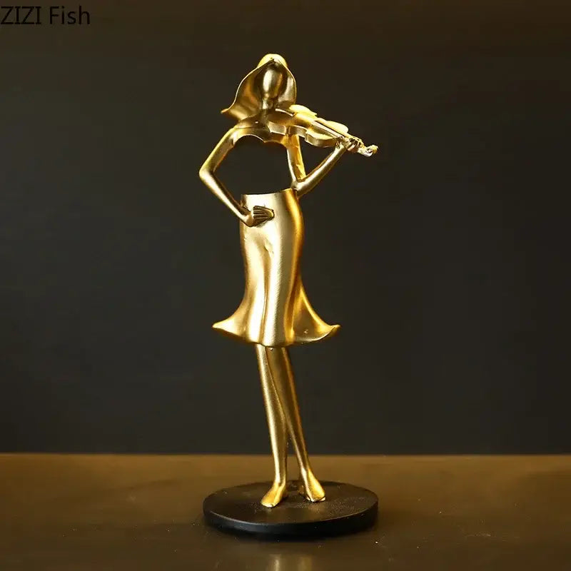 Golden musician resin sculpture of a woman playing violin in flowing dress on black base for aesthetic room decor