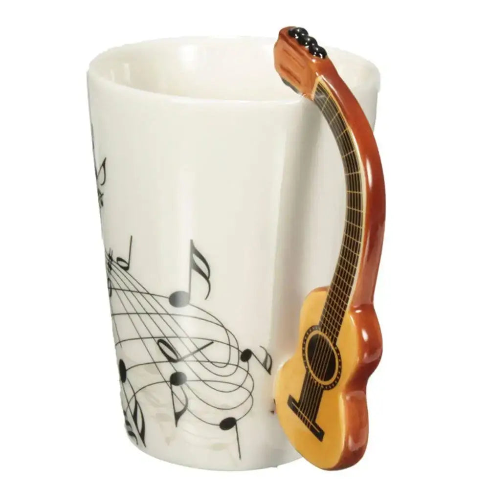 White ceramic acoustic guitar mug with guitar-shaped handle and black musical notes for coffee or tea by DecorBites