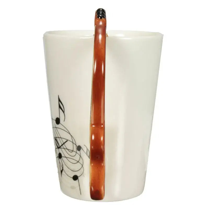 White ceramic acoustic guitar mug with black musical notes and amber handle for coffee and tea by DecorBites