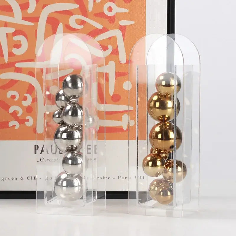 Clear acrylic ball vase stack with polished silver and gold metallic spheres for home decoration and floral display