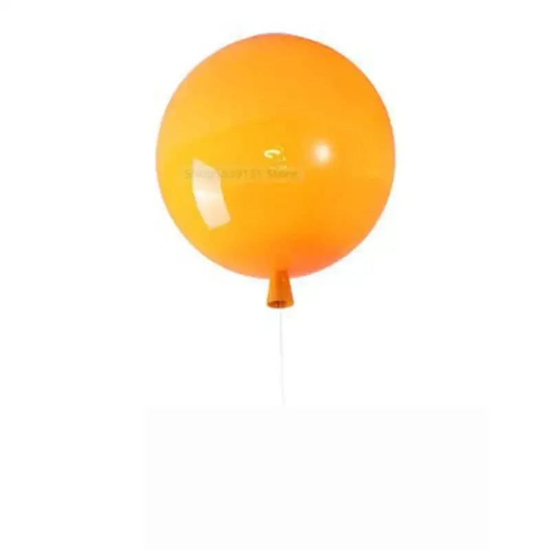 A vibrant orange acrylic balloon ceiling light with matching valve and white string for modern nordic living rooms