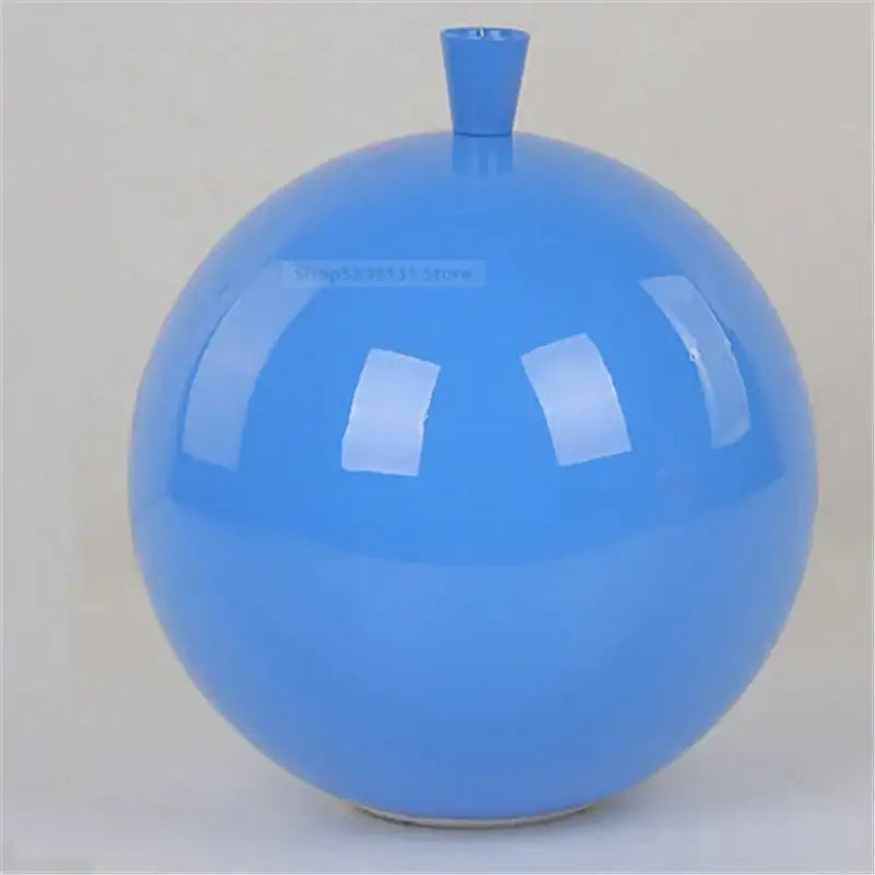 A glossy blue ceramic vase placed under decorbites™ acrylic balloon ceiling lights for modern nordic living room decor