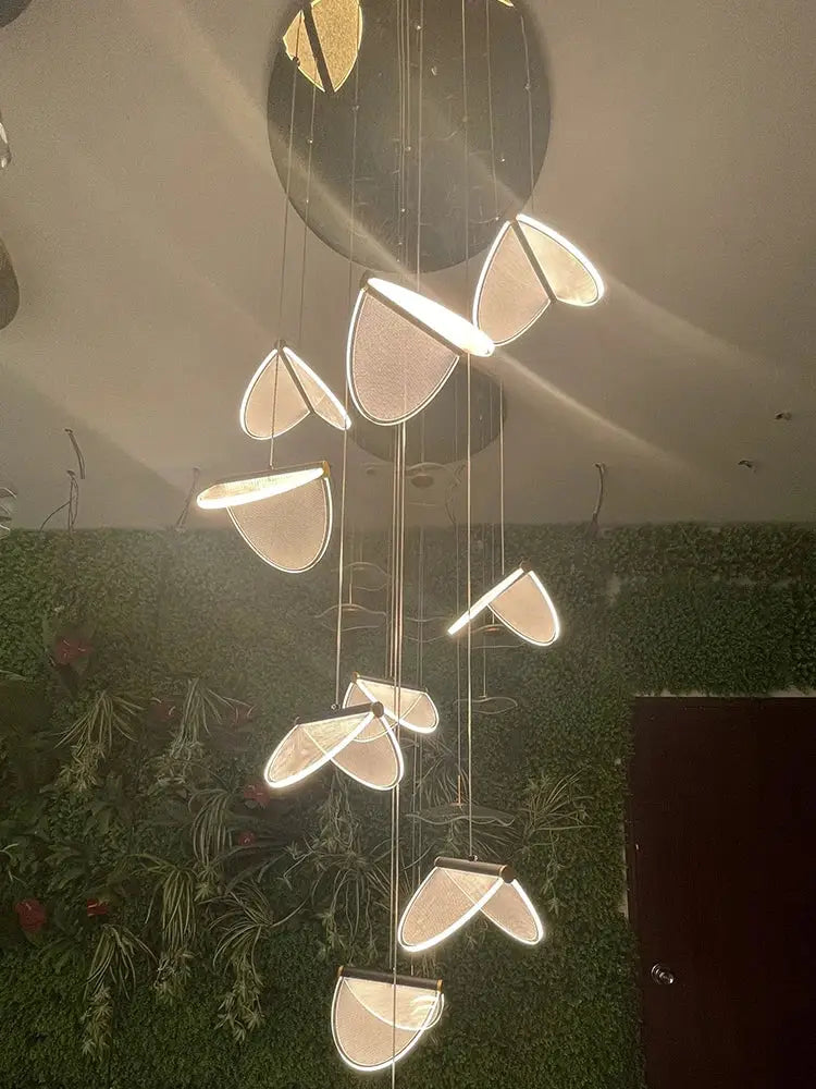 Modern black acrylic blade stair chandelier with illuminated leaf-shaped shades for cafe restaurant and villa ambiance