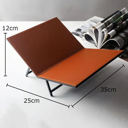 Brown and orange leather desk organizer with minimalist metal frame for home decor beside DecorBites acrylic bookshelf marble base