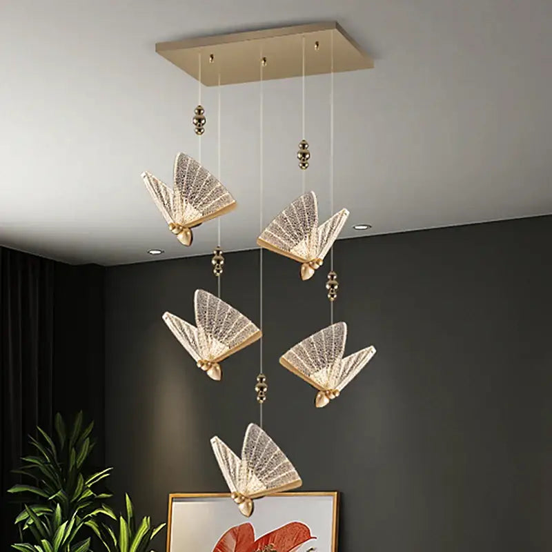 Elegant gold-toned acrylic butterfly chandelier ceiling lamp with translucent fan-shaped crystal wings and metallic accents