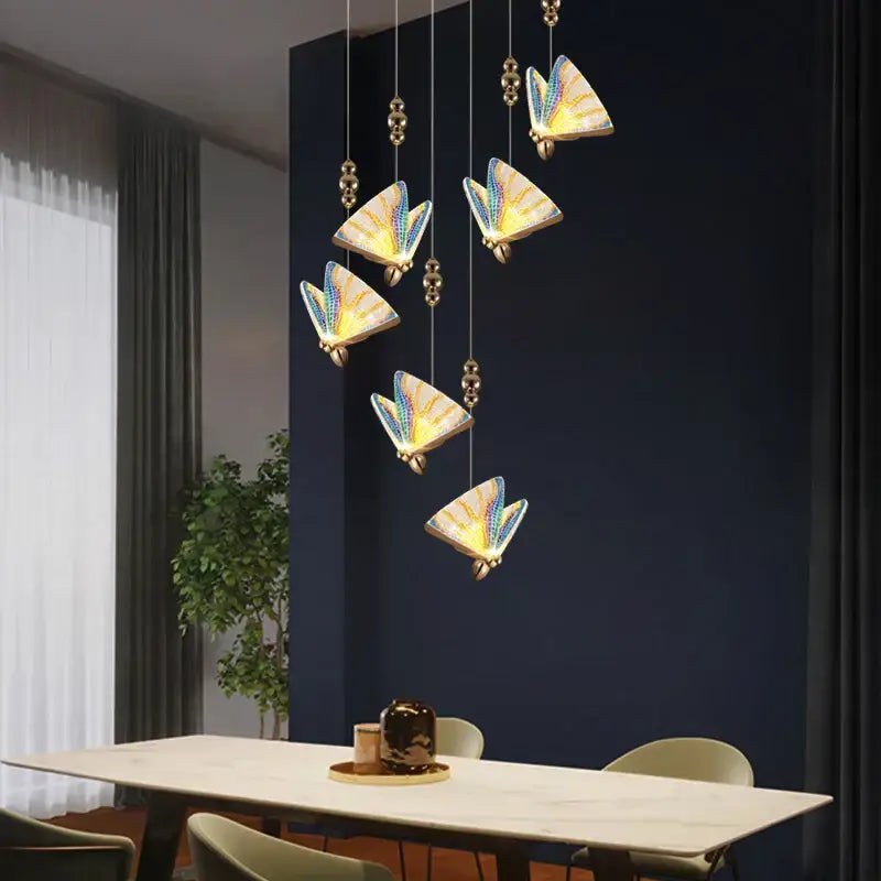 Elegant decorbites acrylic butterfly chandelier ceiling lamp with iridescent blue and gold wings suspended by brass beads