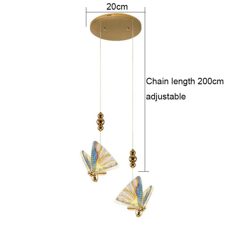 Gold-toned ceiling lamp acrylic butterfly chandelier with iridescent blue and white mosaic wings suspended by chains