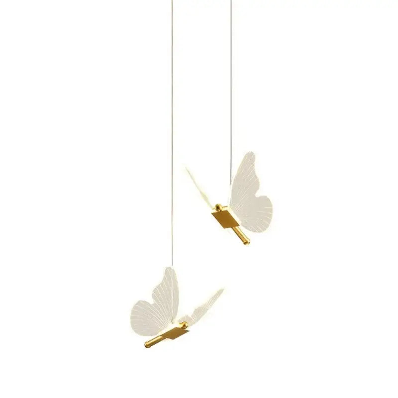 Two elegant white acrylic butterfly led pendant lights with gold-toned fixtures by decorbites hanging from thin cords