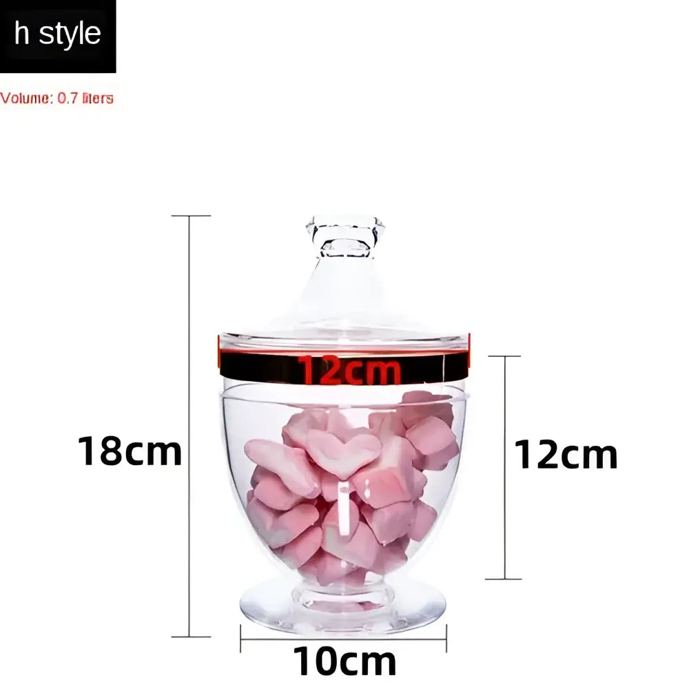 Clear acrylic candy jar with black rim band and lid filled with pink heart candies from decorbites spice jar set