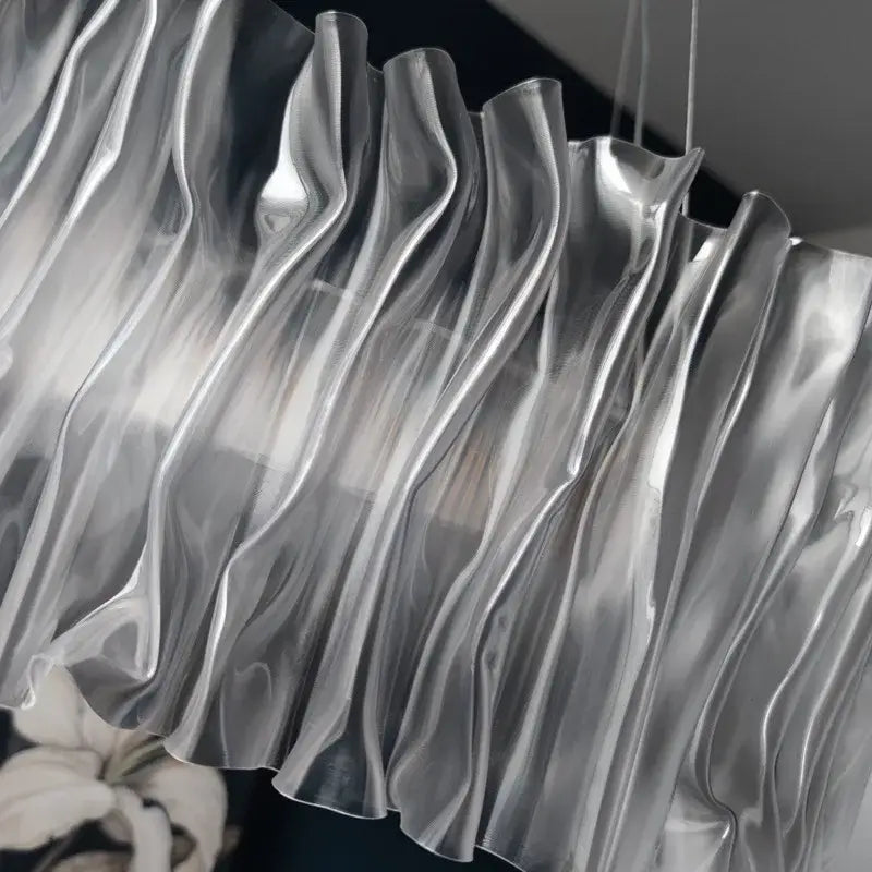 A sleek silver translucent pleated curtain with glossy wave folds for decorbites acrylic ceiling chandelier installation