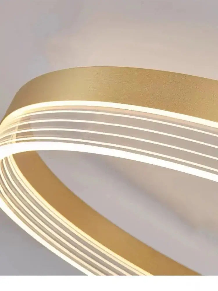 DecorBites™ gold-toned acrylic ceiling chandelier with sleek curved design and multiple illuminated strips for modern spaces