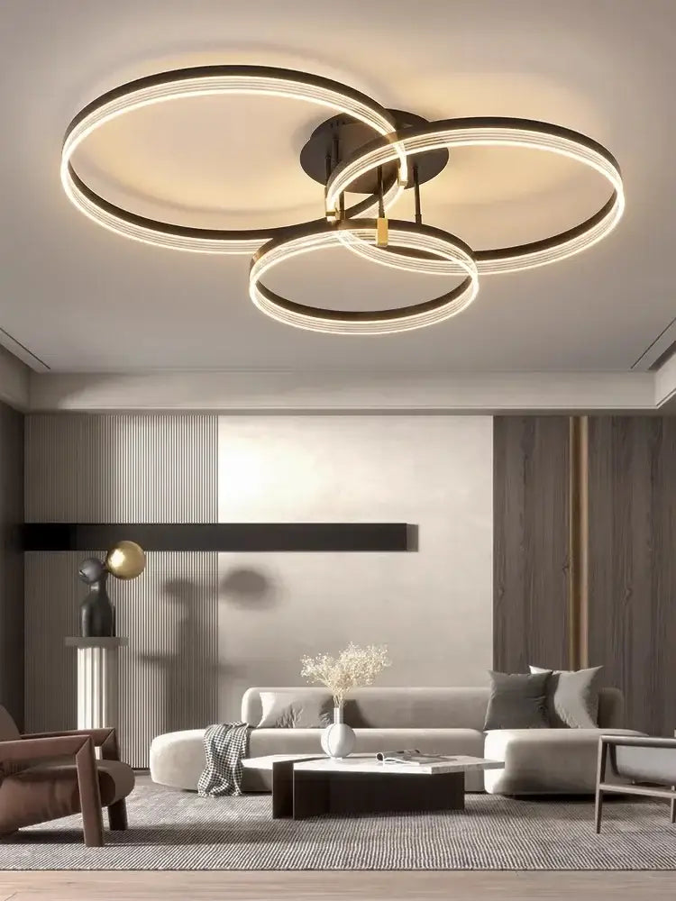 Decorbites acrylic ceiling chandelier with three interlocking black and gold rings for modern living room lighting