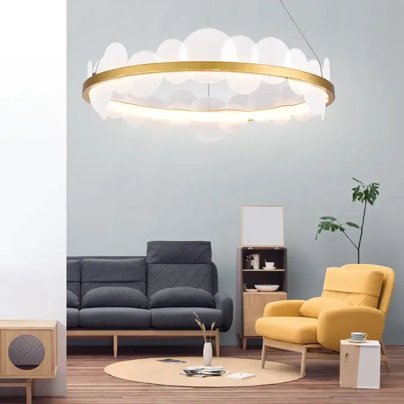 Gold-toned DecorBites™ acrylic ceiling chandelier with translucent white cloud-like shades for modern indoor lighting