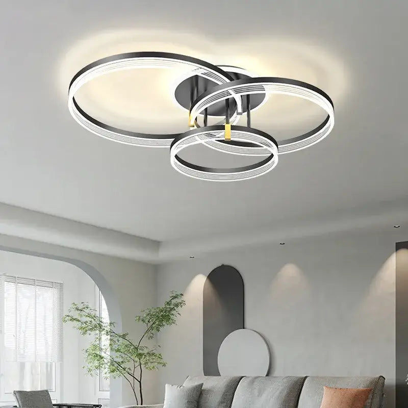 Modern black and white acrylic circle chandelier pendant lights with sleek overlapping ring design for living room decor