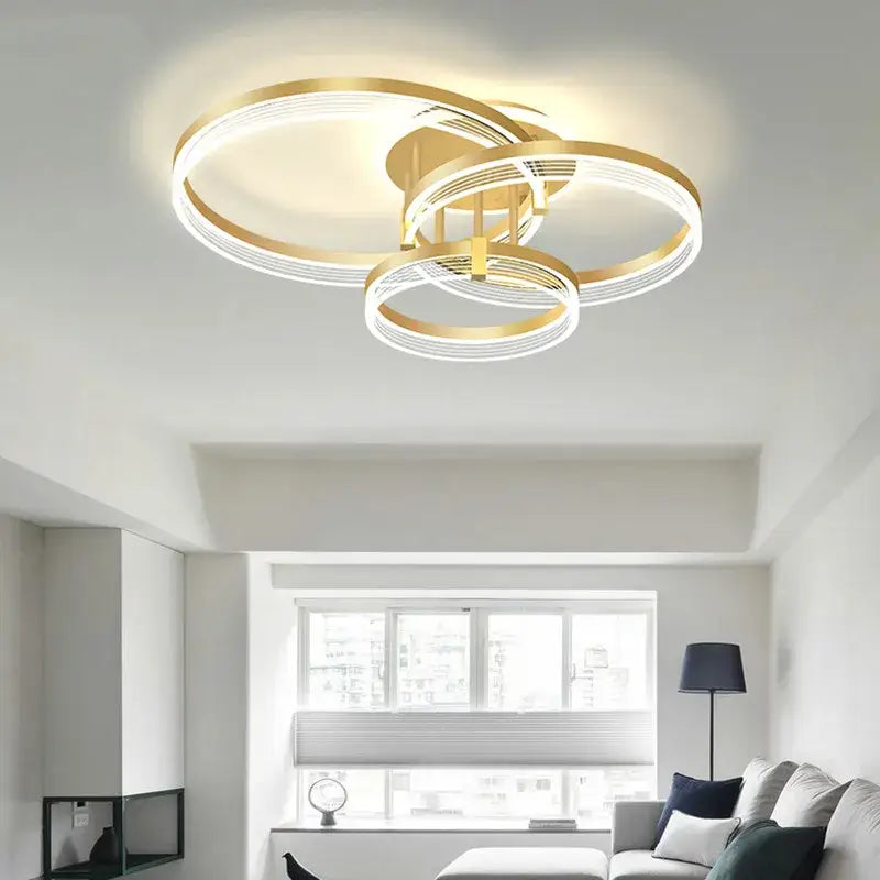 Gold-toned acrylic circle chandelier pendant light with interlocking rings and integrated LED for modern indoor decor