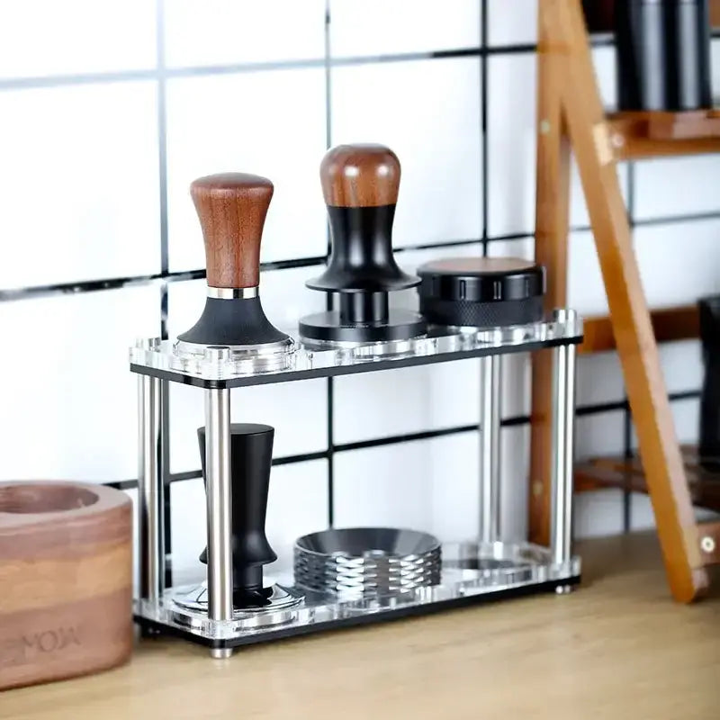 DecorBites acrylic coffee bar utensil rack with clear acrylic and stainless steel holding three wooden-handled tampers