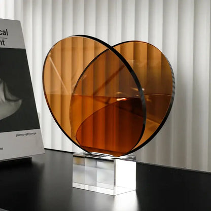 Amber-colored translucent acrylic crystal bookshelf magazine rack with sleek black rim and geometric circular base