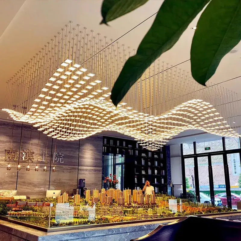 Golden modern DecorBites™ acrylic crystal hanging pendant light with geometric grid design for living room and hotel use