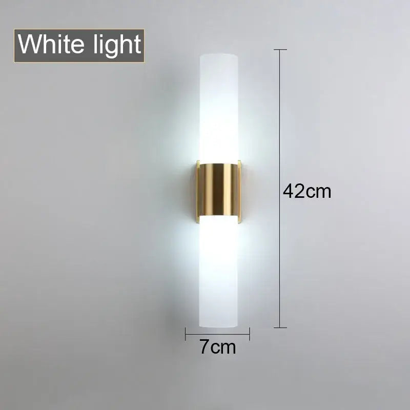 Decorbites™ wall lamp with frosted acrylic cylinder and gold metal bracket emitting soft white light for bedroom and study