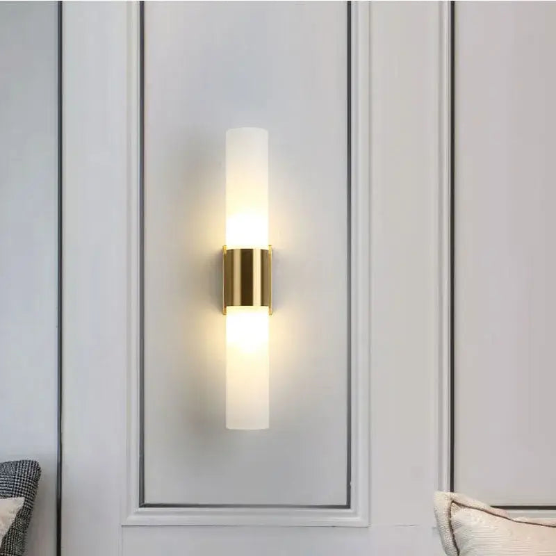 Gold-toned decorbites acrylic cylinder wall lamp with frosted glass and minimalist design for bedroom and living room lighting