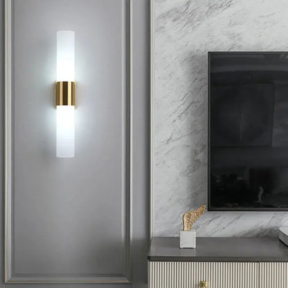 Modern DecorBites™ wall lamp with frosted acrylic cylinder and polished gold metal accents for bedroom and living room