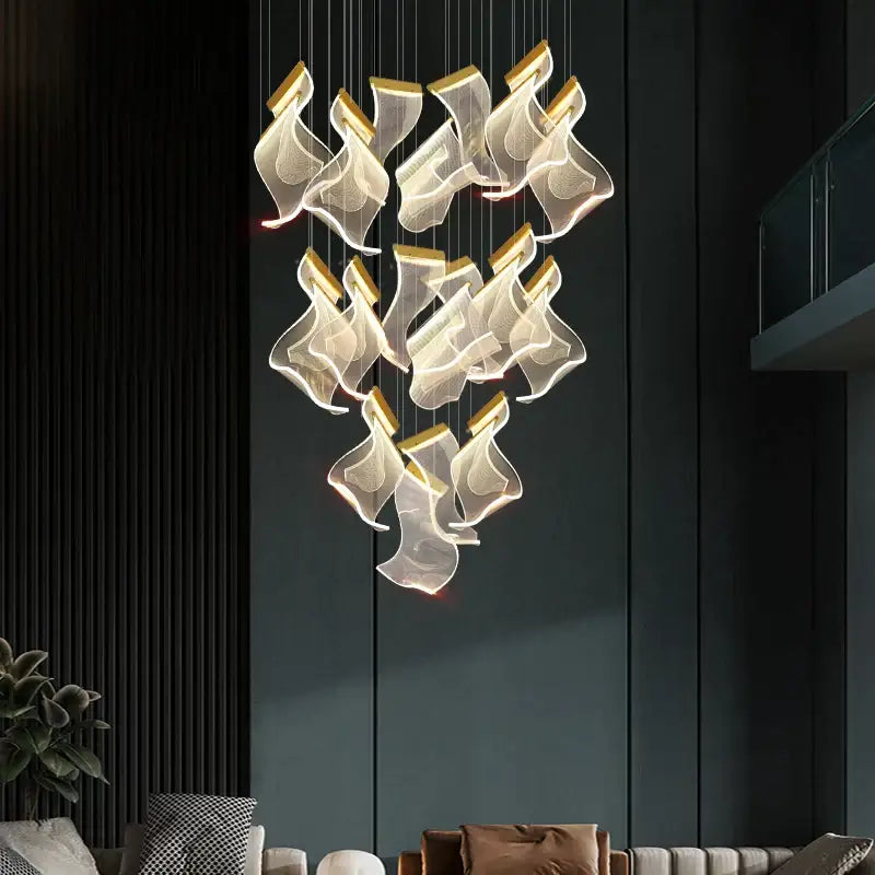 Modern gold-accented acrylic deluxe staircase chandelier with translucent flowing shades for villa lobby lighting