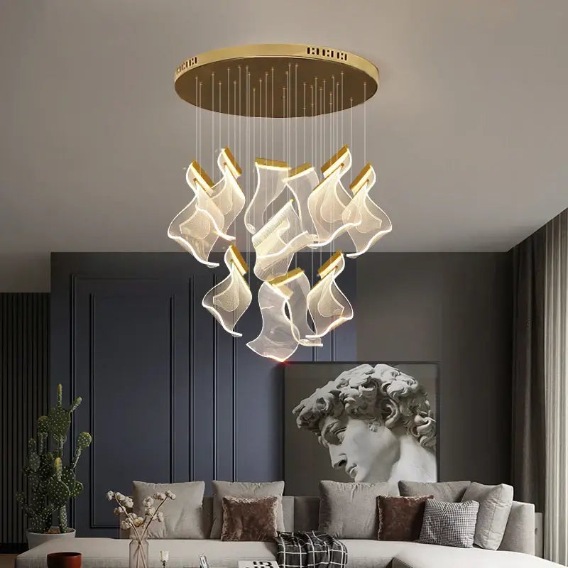 Modern gold-toned acrylic deluxe staircase chandelier with translucent flame-shaped acrylic shades for villa decor