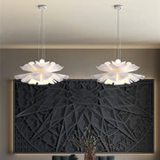 Two elegant white acrylic flower pendant lights shaped like lotus flowers hanging from the ceiling for dining decor