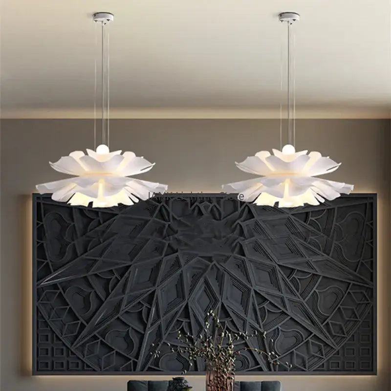 Two elegant white acrylic flower pendant lights shaped like lotus flowers hanging from the ceiling for dining decor