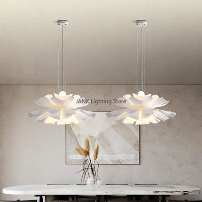 Two elegant white acrylic flower chandelier pendant lights with layered petals and glowing centers for dining and bedroom decor