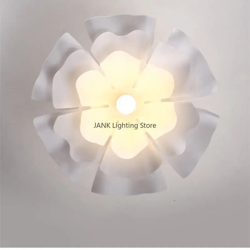 White acrylic flower chandelier pendant light with petal-shaped design and soft glowing center for dining and bedroom decor