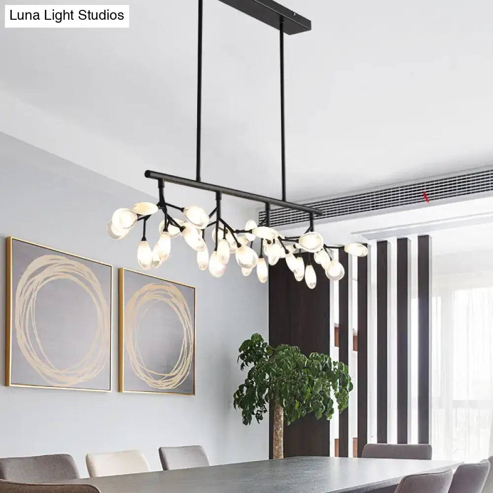 Black metal island lighting fixture with frosted glass globes in a modern branching design for dining rooms