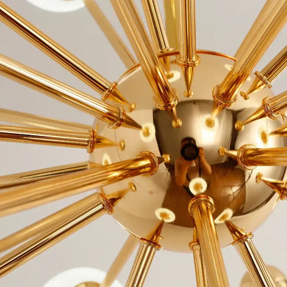 Golden brass decorbites acrylic molecule chandelier with radiating rods and reflective spherical center for dining room lighting
