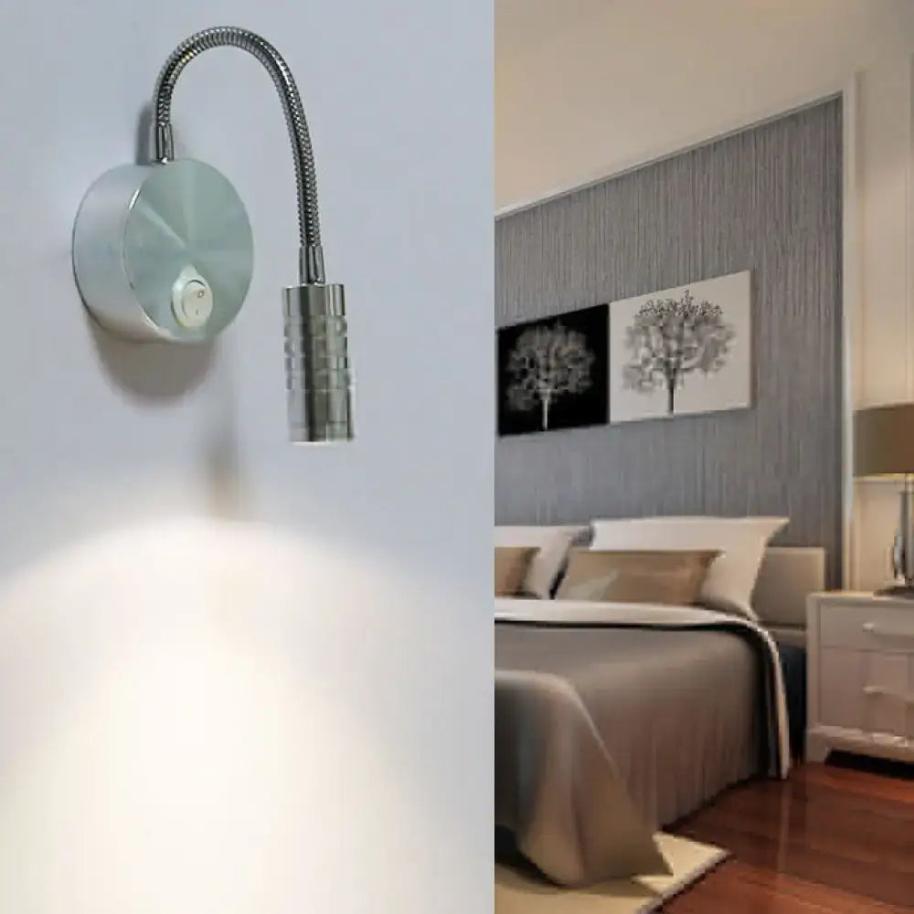 Modern chrome gooseneck cylinder wall mount reading lamp with silver metallic finish and adjustable head for bedroom use