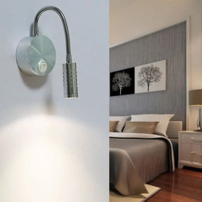 Modern chrome gooseneck cylinder wall mount reading lamp with silver metallic finish and adjustable head for bedroom use