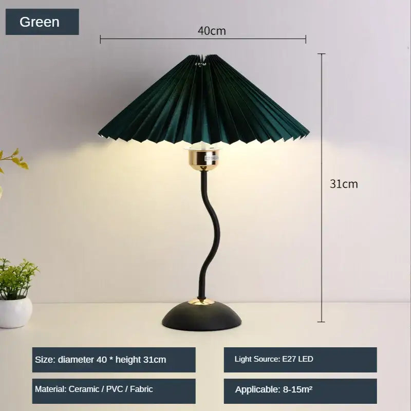 Decorbites adjustable pleated table lamp with dark green fabric shade curved black base and gold-toned accents