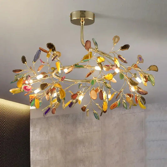 A decorbites agate branch chandelier in gold with intricate translucent glass leaves for dining room lighting
