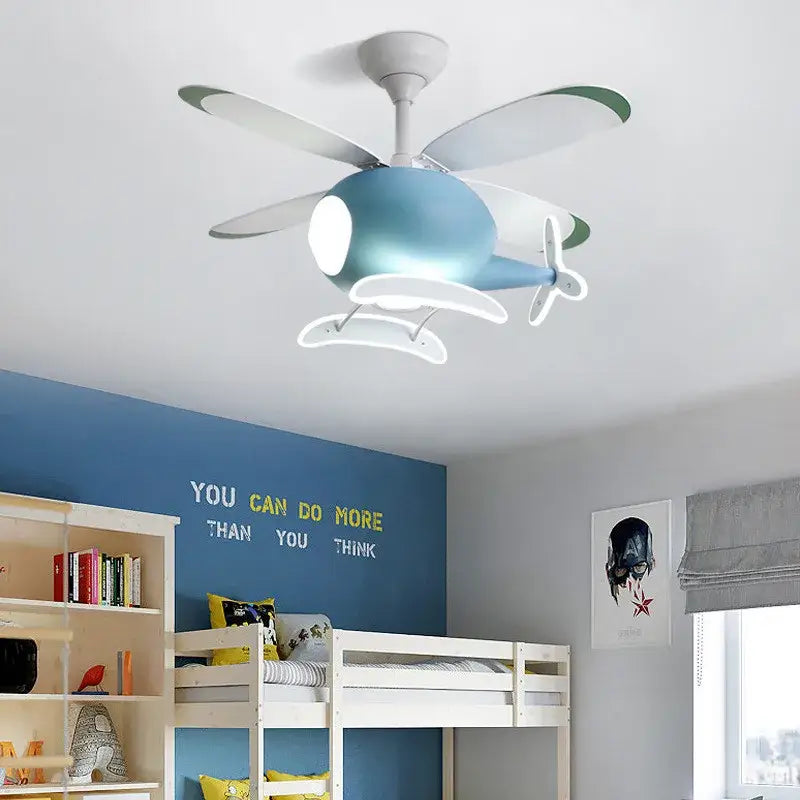 Blue airplane-shaped aircraft ceiling fan chandelier with white propellers and LED cockpit lights by DecorBites